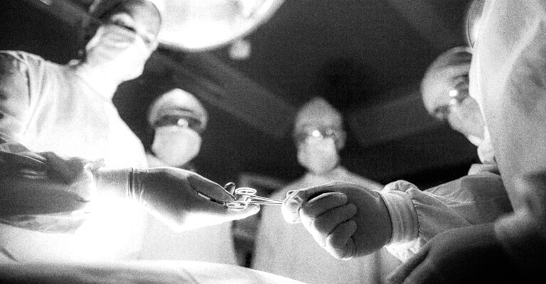 Imagem em preto e branco de sala de cirurgia